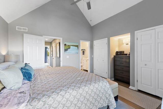 bedroom featuring hardwood / wood-style floors, ensuite bathroom, high vaulted ceiling, and ceiling fan