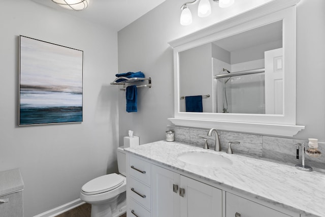 bathroom with vanity, toilet, and walk in shower