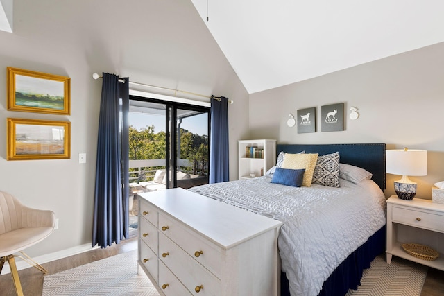 bedroom featuring access to outside, light hardwood / wood-style flooring, and high vaulted ceiling