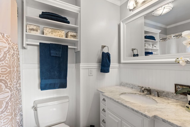 bathroom with vanity, crown molding, and toilet