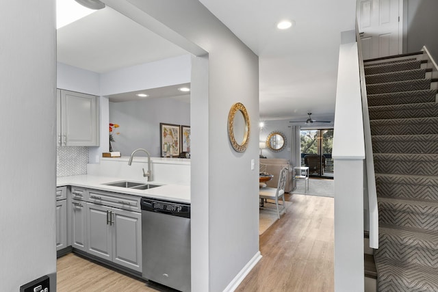 kitchen featuring sink, light hardwood / wood-style flooring, dishwasher, and gray cabinets