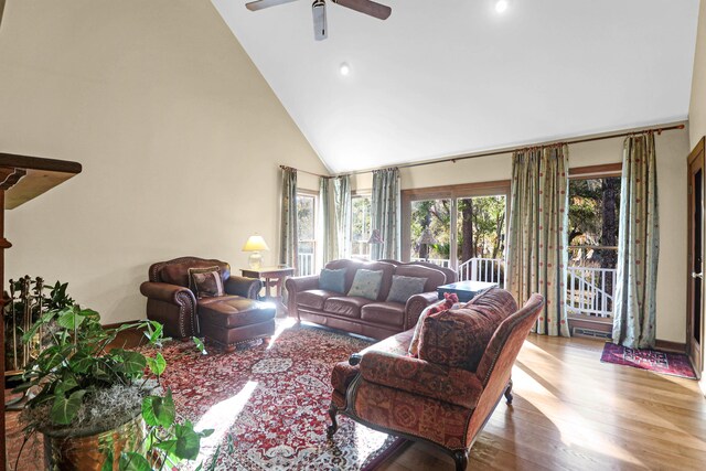 living room featuring high vaulted ceiling, light wood-type flooring, and ceiling fan