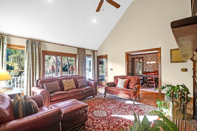 living room featuring hardwood / wood-style flooring, high vaulted ceiling, and ceiling fan