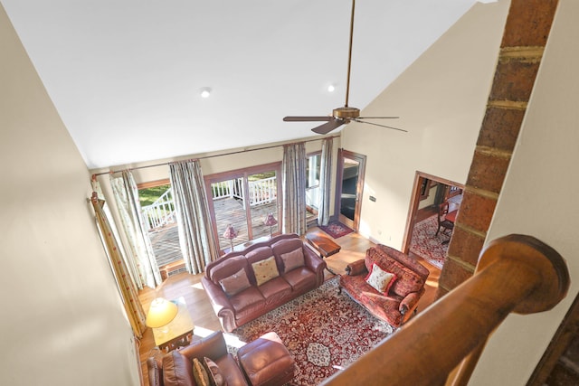 living room featuring hardwood / wood-style flooring, high vaulted ceiling, and ceiling fan