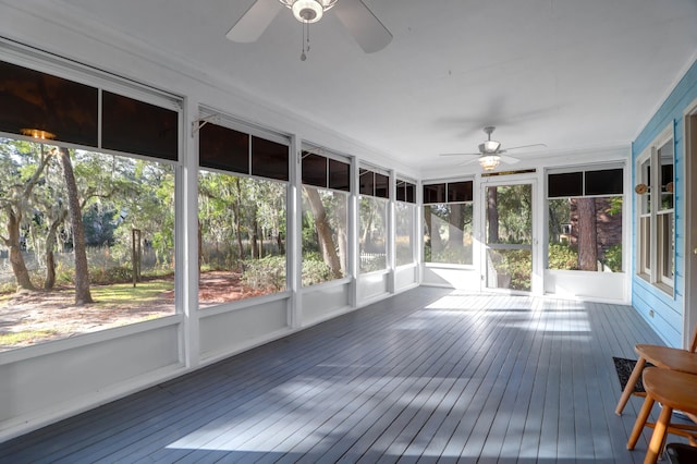 unfurnished sunroom featuring ceiling fan