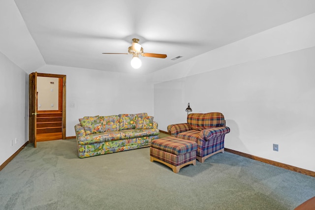 living area featuring lofted ceiling, carpet, and ceiling fan