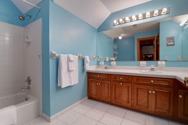 bathroom with vanity, tiled shower / bath, tile patterned flooring, and vaulted ceiling