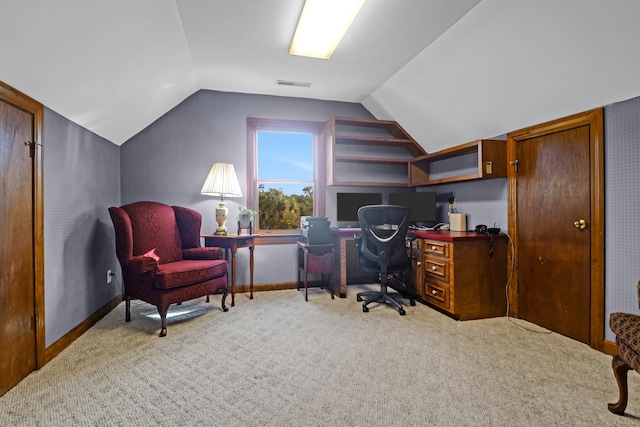 carpeted home office featuring lofted ceiling