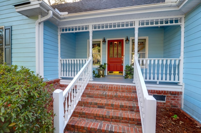 view of exterior entry with covered porch