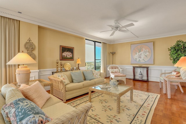 living room with parquet floors, ornamental molding, and ceiling fan