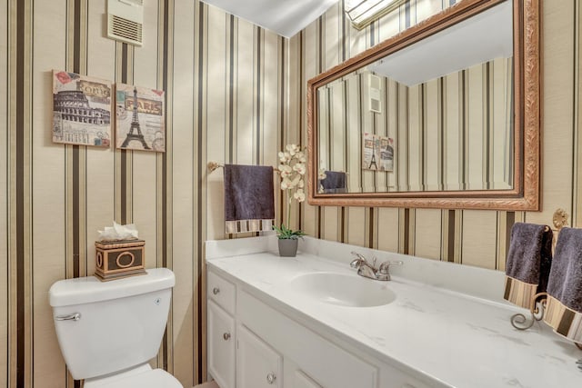 bathroom featuring vanity and toilet