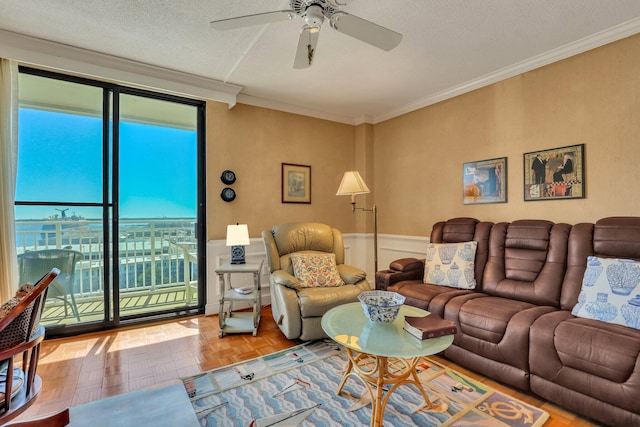 living room featuring parquet flooring, crown molding, a textured ceiling, and ceiling fan