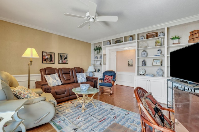 living room featuring crown molding, parquet floors, built in features, and ceiling fan