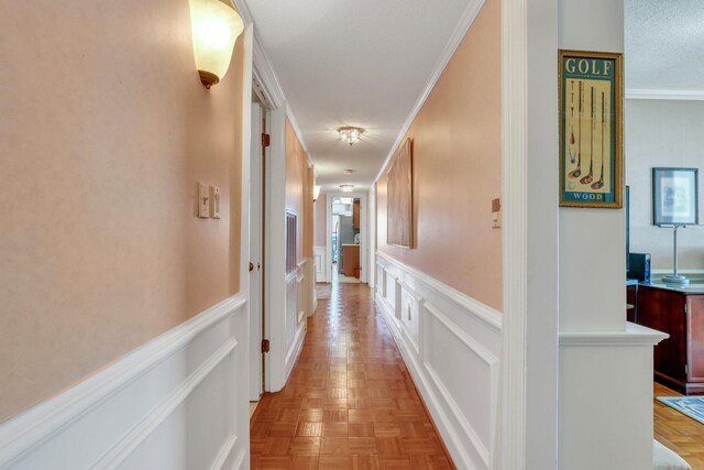 hallway featuring light parquet flooring and ornamental molding