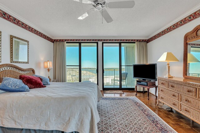 bedroom featuring ornamental molding, access to exterior, a textured ceiling, and ceiling fan