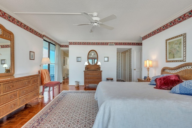 bedroom featuring parquet flooring, ornamental molding, a textured ceiling, and ceiling fan