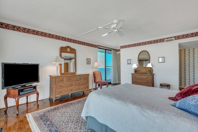 bedroom featuring parquet flooring, ceiling fan, crown molding, and a textured ceiling