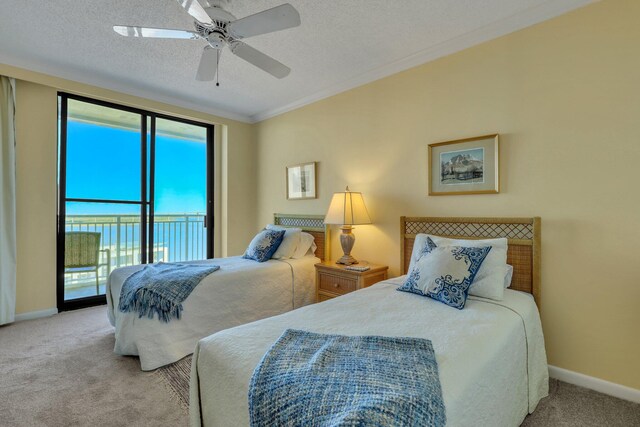 carpeted bedroom with crown molding, a textured ceiling, access to outside, and ceiling fan