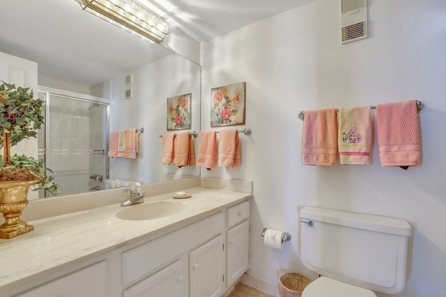 bathroom with vanity, toilet, and walk in shower