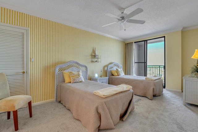 carpeted bedroom featuring ornamental molding, access to outside, a textured ceiling, and ceiling fan