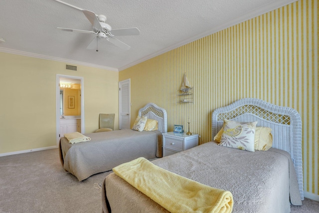 carpeted bedroom with ornamental molding, a textured ceiling, connected bathroom, and ceiling fan