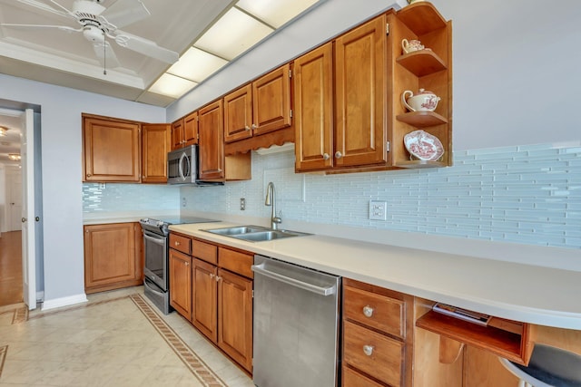 kitchen with backsplash, sink, light tile patterned floors, appliances with stainless steel finishes, and ceiling fan