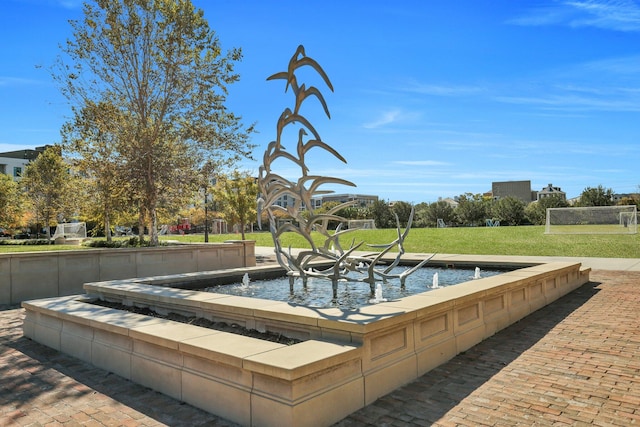 view of swimming pool with a yard