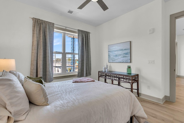 bedroom with ceiling fan and light hardwood / wood-style floors