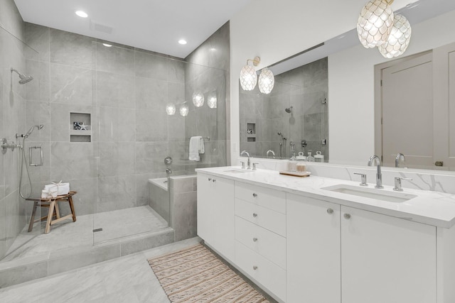 bathroom featuring vanity and a shower with door