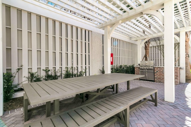 view of patio with a pergola and area for grilling