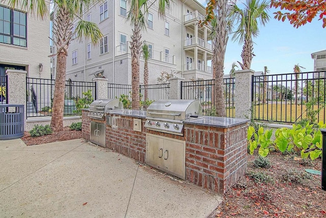 view of patio / terrace with an outdoor kitchen, cooling unit, and a grill