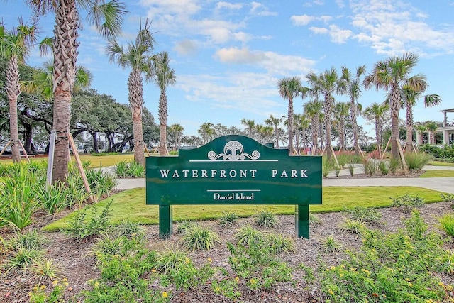 community sign featuring a lawn