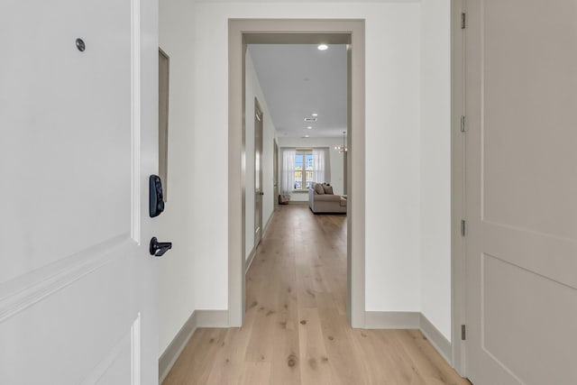 hallway with light hardwood / wood-style flooring