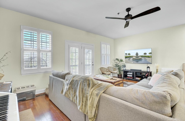 living area featuring a healthy amount of sunlight, ceiling fan, visible vents, and hardwood / wood-style flooring