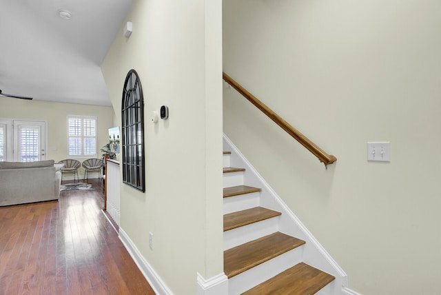 stairs featuring baseboards and hardwood / wood-style floors