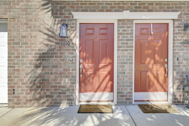 property entrance featuring brick siding