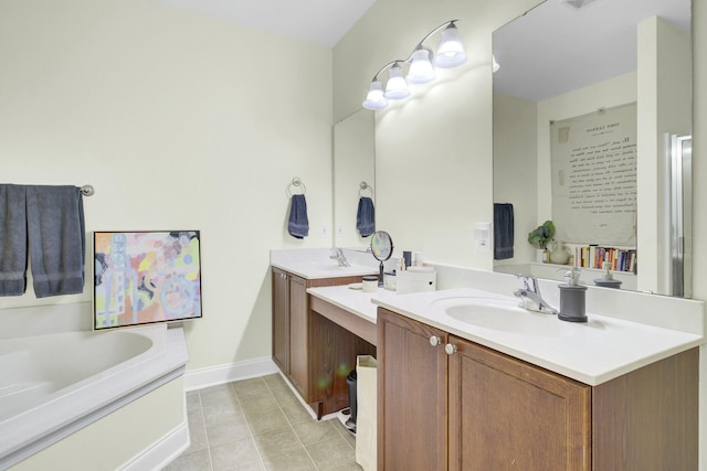 full bath with baseboards, two vanities, a sink, tile patterned flooring, and a bath