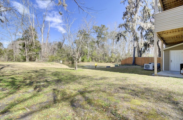 view of yard featuring ac unit and fence