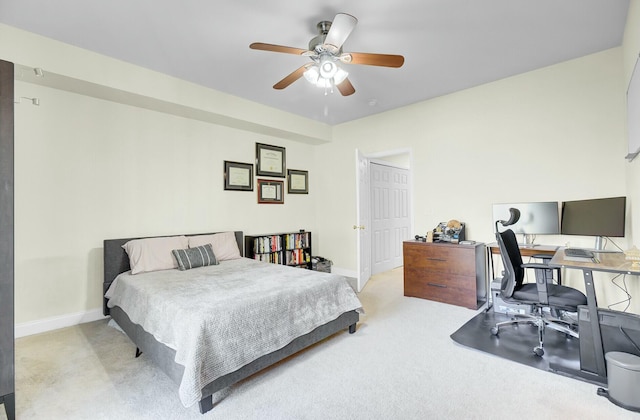 carpeted bedroom with ceiling fan and baseboards