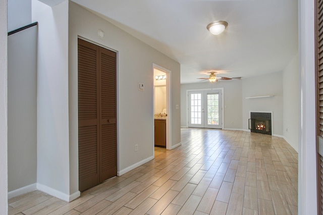 unfurnished living room featuring ceiling fan and light hardwood / wood-style flooring