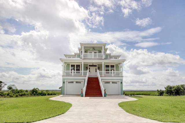 125 Oak Bay Dr, Georgetown, SC 29440 - raised beach house with stairs, covered porch, a front yard, and a garage