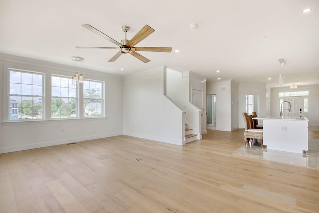 125 Oak Bay Dr, Georgetown, SC 29440 - unfurnished living room featuring light wood-style floors, stairs, ornamental molding, a ceiling fan, and recessed lighting