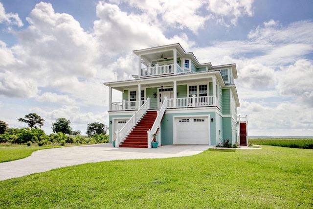 125 Oak Bay Dr, Georgetown, SC 29440 - coastal home with stairway, covered porch, a ceiling fan, and a front lawn