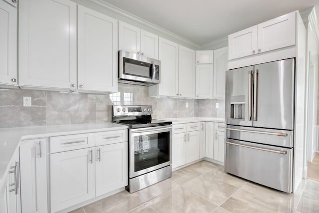 125 Oak Bay Dr, Georgetown, SC 29440 - kitchen featuring stainless steel appliances, light countertops, white cabinets, tasteful backsplash, and crown molding