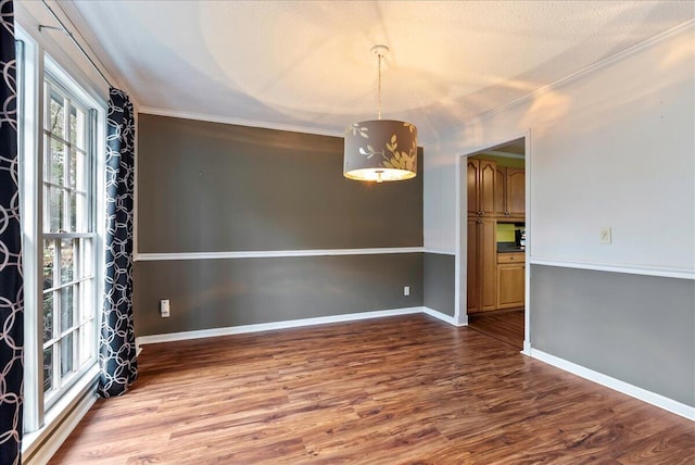 unfurnished dining area featuring crown molding and hardwood / wood-style floors