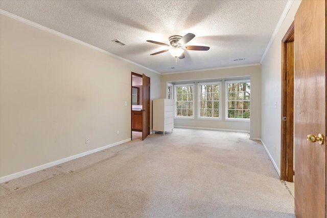 unfurnished room with ornamental molding, light colored carpet, a textured ceiling, and ceiling fan