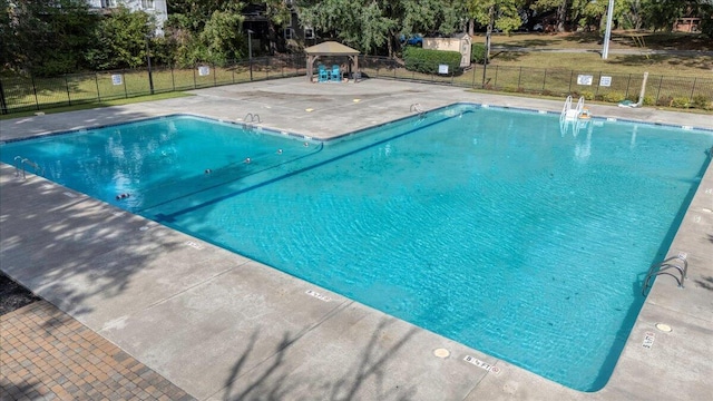 view of swimming pool featuring a gazebo and a patio area