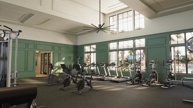exercise room featuring a decorative wall and a towering ceiling