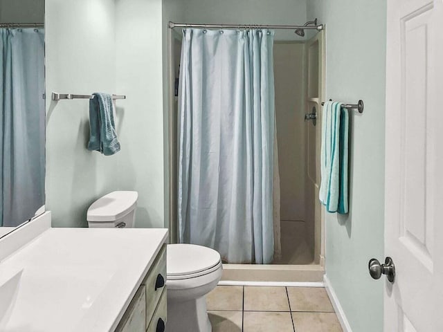 bathroom with vanity, tile patterned flooring, toilet, and a shower stall