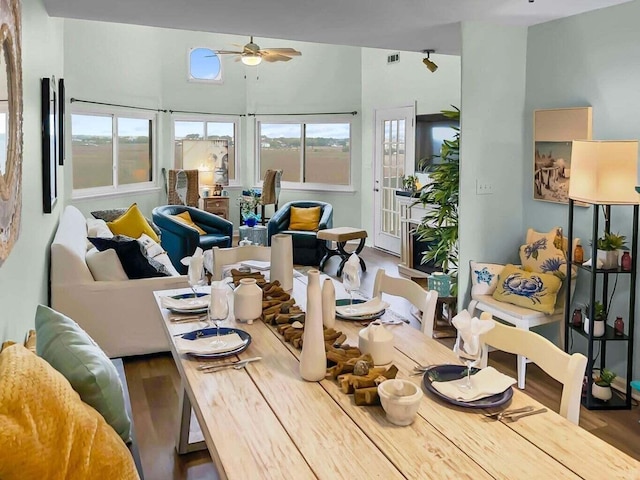 dining space featuring visible vents, ceiling fan, and wood finished floors